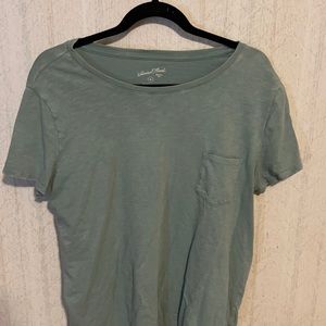 Light teal shirt sleeve shirt with from pocket. Light weight crew neck t-shirt.